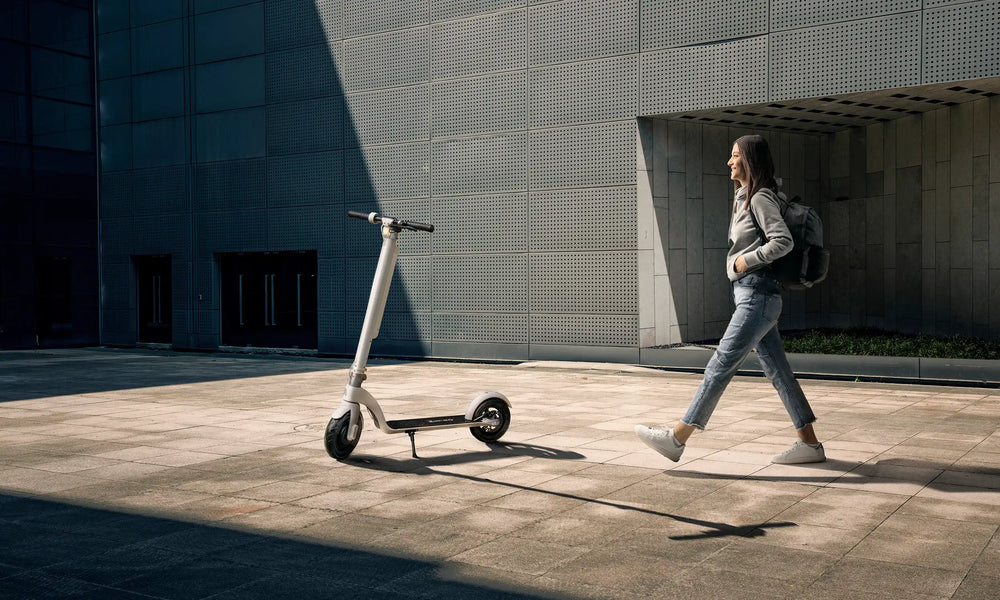 Walking past an electric scooter on a city street